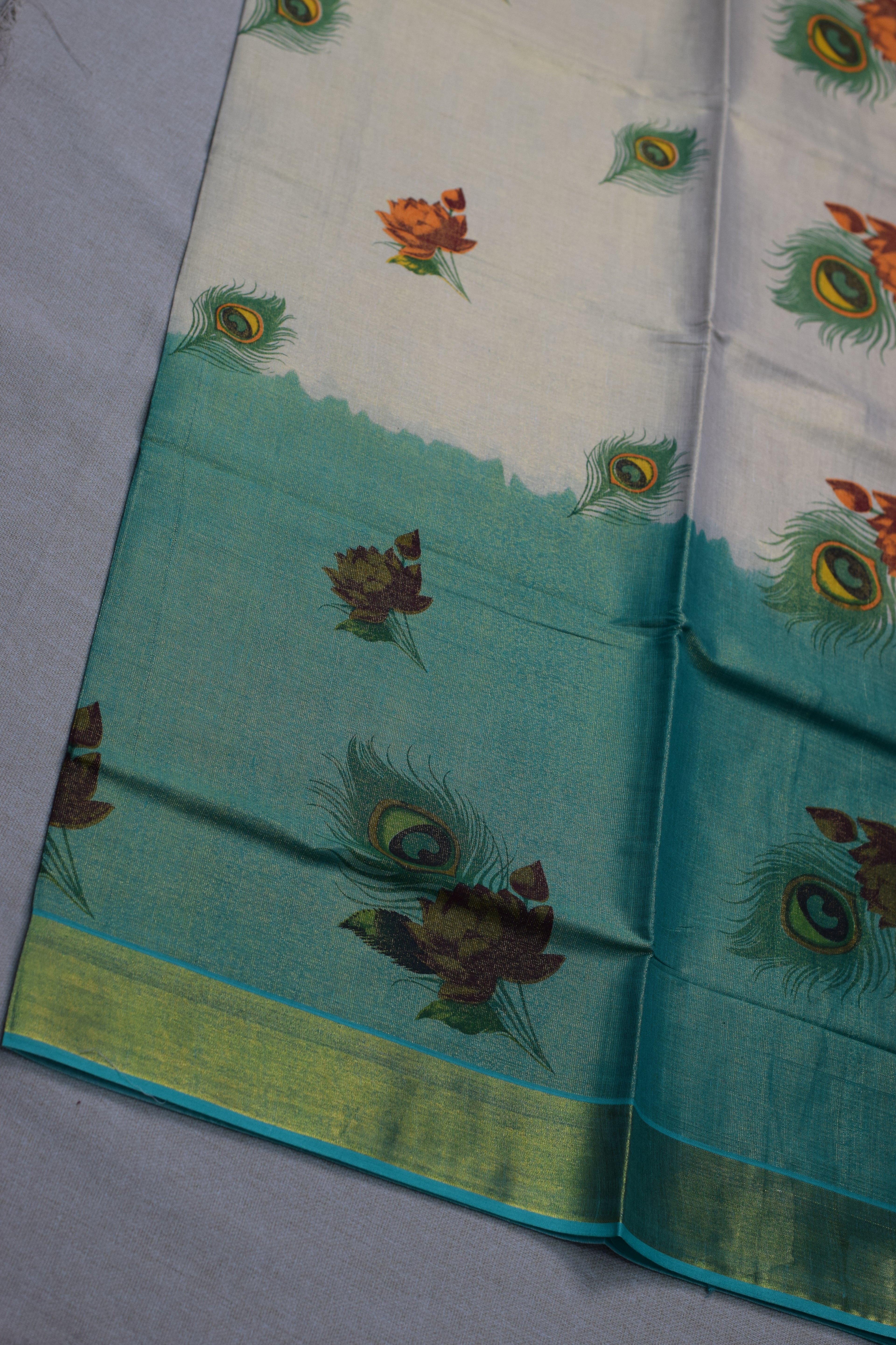 Kerala Kasavu Cotton Saree with Teal Tissue Pallu & Peacock Feather Block Print