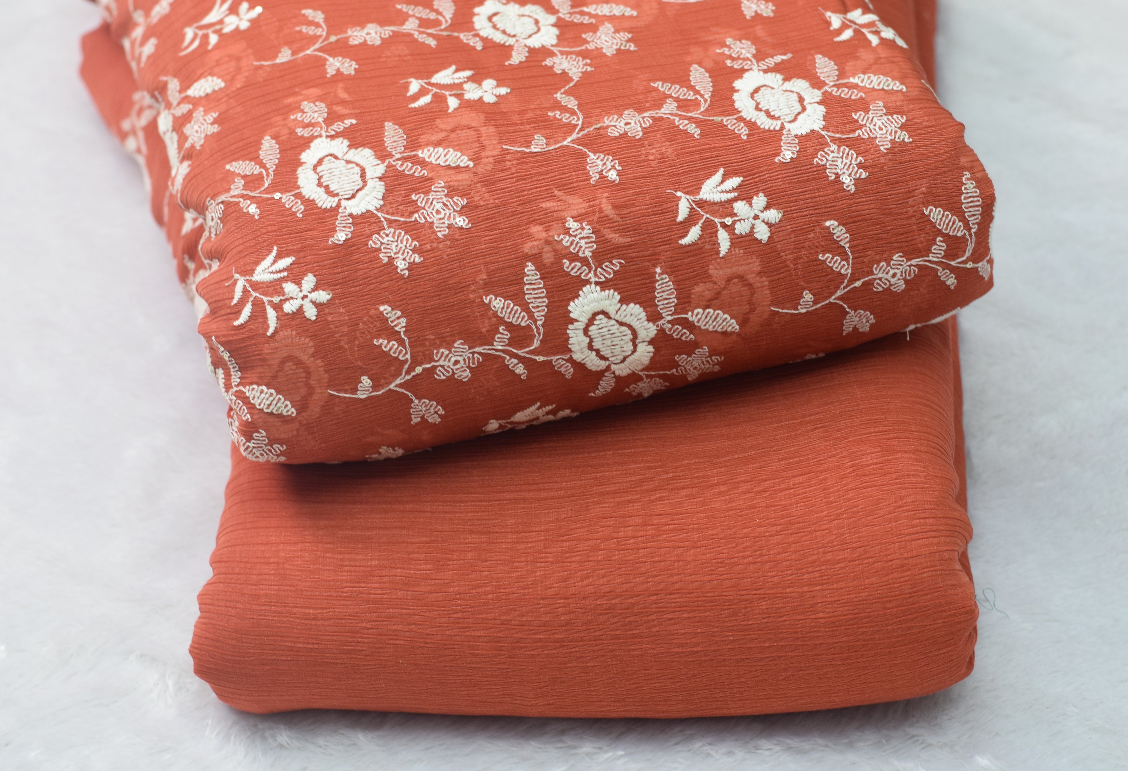 Rust Orange Crushed Georgette Fabric with Elegant White Floral Embroidery – - 44 Inches Width